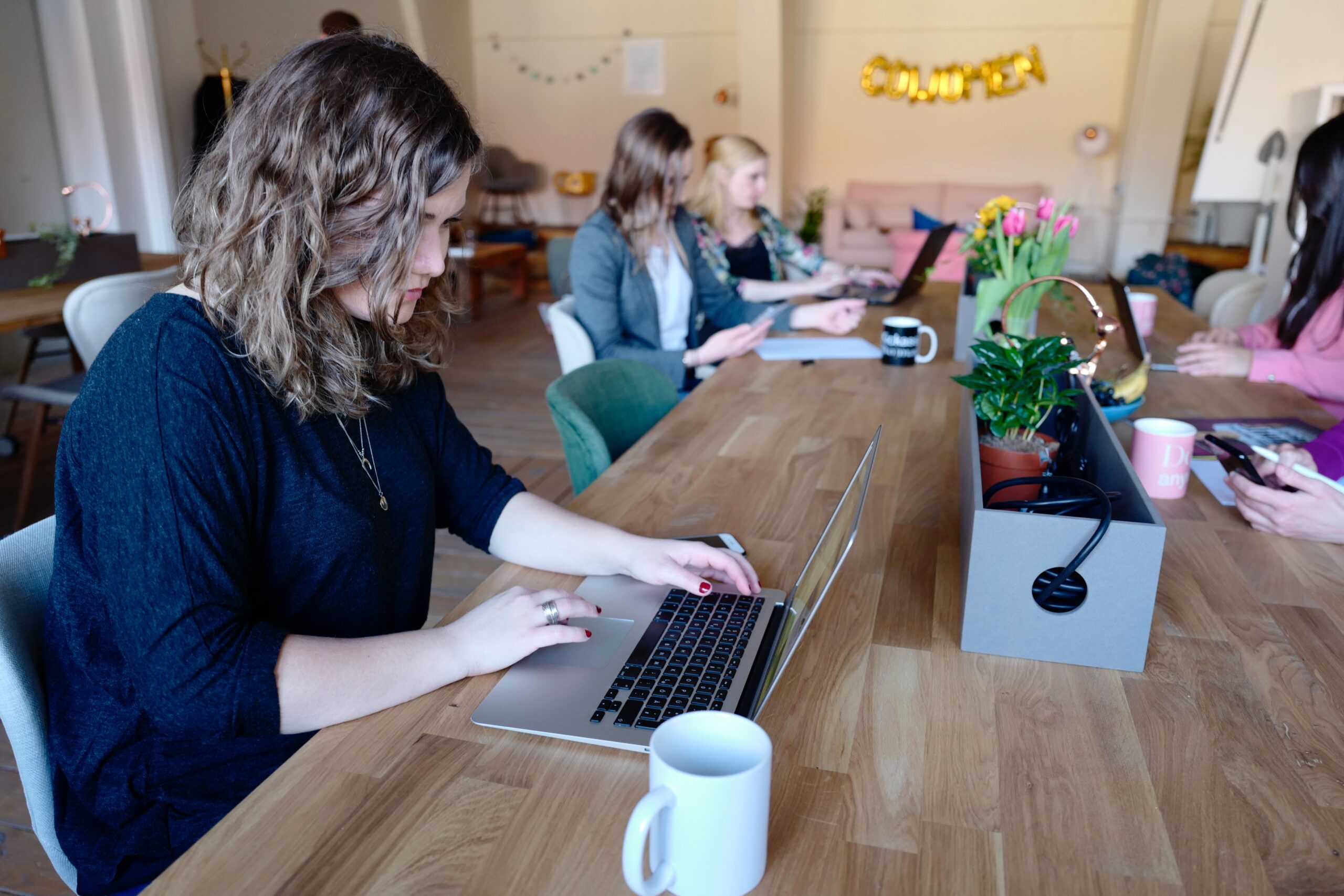 Women working on laptops together